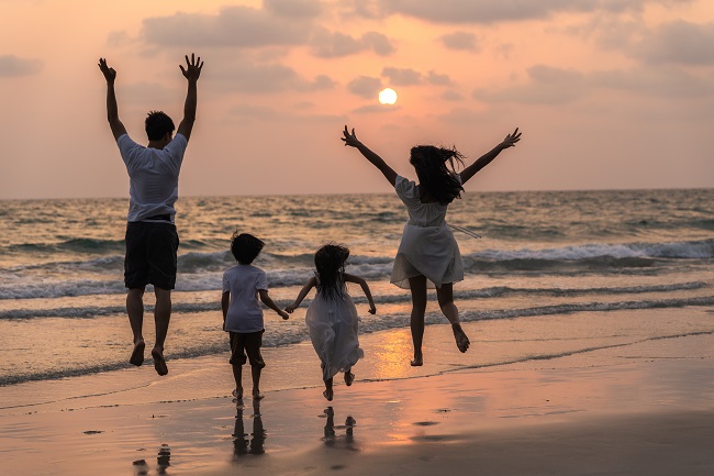 asian young happy family enjoy vacation beach evening dad mom kid relax running together near sea while silhouette sunset lifestyle travel holiday vacation summer concept