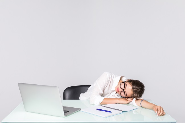 businesswoman asleep her desk isolated white background 1