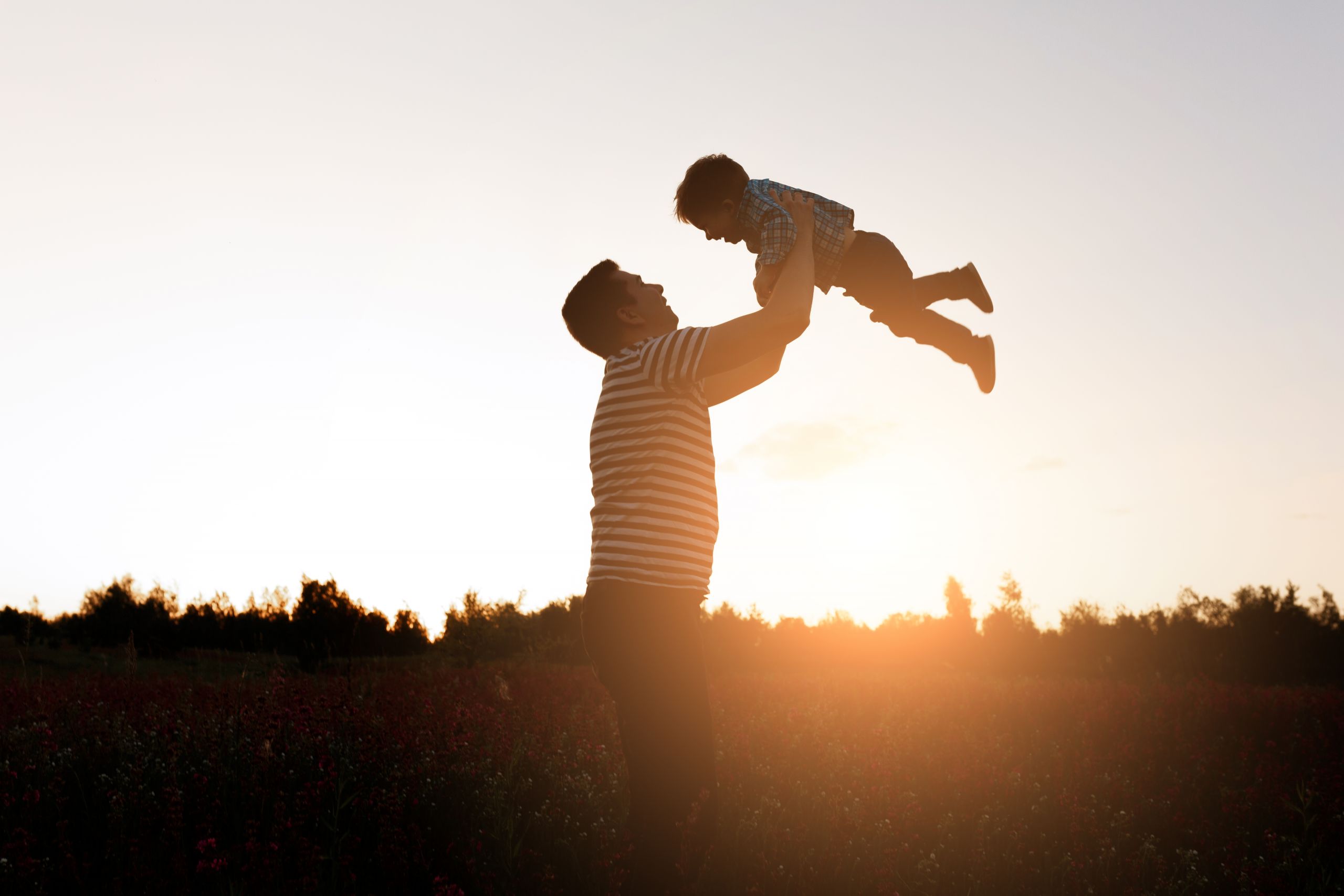 father son playing park sunset time happy family having fun outdoor scaled